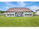 Expansive backyard view of a home with a covered patio and manicured lawn at 17804 Brewster Grn, Lutz, FL 33559