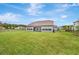 Expansive backyard view with green grass leading to a patio at 17804 Brewster Grn, Lutz, FL 33559