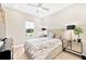 Well-lit bedroom features wood-look floors, a neutral color palette, and a large window with neighborhood views at 17804 Brewster Grn, Lutz, FL 33559
