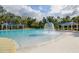 Community swimming pool with water features and shaded seating areas at 17804 Brewster Grn, Lutz, FL 33559