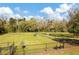 Fenced community dog park featuring green space, benches, and agility equipment at 17804 Brewster Grn, Lutz, FL 33559