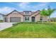 Charming single-story home features a stone facade, well-manicured lawn, and a two-car garage at 17804 Brewster Grn, Lutz, FL 33559