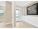 Elegant foyer with white trim, light wood flooring, and a decorative wall art piece at 17804 Brewster Grn, Lutz, FL 33559