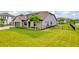 A spacious front yard with lush green grass and landscaping, complemented by a charming home exterior at 17804 Brewster Grn, Lutz, FL 33559