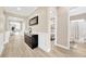 Inviting hallway with stylish decor, leading to bedrooms and bathrooms with wood-look tile floors at 17804 Brewster Grn, Lutz, FL 33559