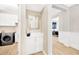 Hallway leading to the laundry room with washer, dryer, and modern cabinetry at 17804 Brewster Grn, Lutz, FL 33559
