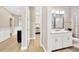 Hallway leading to a powder room features wood-look tile floors and a stylish vanity with a sink at 17804 Brewster Grn, Lutz, FL 33559