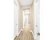 Inviting hallway with wood-look tile flooring leading to various rooms in the home at 17804 Brewster Grn, Lutz, FL 33559