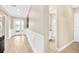 Inviting hallway showcases wood-look tile, wainscoting, a stylish front door, and access to a modern powder room at 17804 Brewster Grn, Lutz, FL 33559