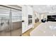Bright, open kitchen with stainless steel refrigerator, built-in oven, and quartz countertop at 17804 Brewster Grn, Lutz, FL 33559