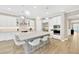 Bright, modern kitchen featuring an island with seating, stainless steel appliances, and pendant lighting at 17804 Brewster Grn, Lutz, FL 33559