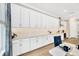 Bright kitchen featuring white cabinets, subway tile backsplash, and modern appliances at 17804 Brewster Grn, Lutz, FL 33559