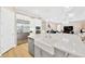 A bright kitchen showcases a sink with a white island, stainless steel appliances, and wooden floors at 17804 Brewster Grn, Lutz, FL 33559