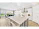 Spacious kitchen with island seating, stainless steel appliances, modern lighting, and an adjacent dining area at 17804 Brewster Grn, Lutz, FL 33559