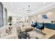 Spacious living room with modern decor, including sofas, lighting, and an open view to the kitchen at 17804 Brewster Grn, Lutz, FL 33559