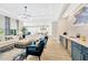 Comfortable living room featuring a bar area, large sofa, and an open view of the kitchen at 17804 Brewster Grn, Lutz, FL 33559
