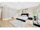 Large main bedroom showcasing a tray ceiling, modern lighting, and ample natural light at 17804 Brewster Grn, Lutz, FL 33559