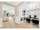 Bright home office with stylish decor, including a modern desk, cabinets, and a sophisticated lighting fixture at 17804 Brewster Grn, Lutz, FL 33559