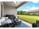 Relaxing covered patio with comfortable seating and a view of the lush, green backyard at 17804 Brewster Grn, Lutz, FL 33559