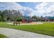 A colorful community playground is shaded and offers a fun play space at 17804 Brewster Grn, Lutz, FL 33559