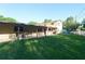 Expansive backyard featuring a covered patio and a well-maintained lawn at 18121 Geraci Rd, Lutz, FL 33548