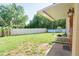 View of the backyard with a white fence and green grass at 18121 Geraci Rd, Lutz, FL 33548