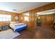 This bedroom offers wood paneling, tile floors, a view of the kitchen and a large window at 18121 Geraci Rd, Lutz, FL 33548