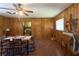Dining room with wood paneled walls, tile floors, and views through doorways to other rooms of the home at 18121 Geraci Rd, Lutz, FL 33548