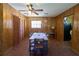 Open concept dining room features wood paneled walls and tile floors with views through doorways to other rooms at 18121 Geraci Rd, Lutz, FL 33548