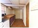 Hallway with a tile floor, brown doors and cabinets at 18121 Geraci Rd, Lutz, FL 33548