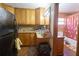 This kitchen features wood cabinets, tiled backsplash, granite countertops, and direct access to the bathroom at 18121 Geraci Rd, Lutz, FL 33548