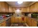 Updated kitchen with wood cabinets, stone countertops, stainless steel dishwasher and sink with a tiled backsplash at 18121 Geraci Rd, Lutz, FL 33548