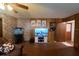 Inviting living room with decorative stone accent wall, paneled walls and an entertainment center with mounted television at 18121 Geraci Rd, Lutz, FL 33548