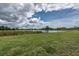 Backyard featuring a lush lawn, pond view, and foliage at 190 Rain Berry Ave, Ruskin, FL 33570