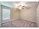 Bedroom featuring gray carpet, ceiling fan, and a closet at 190 Rain Berry Ave, Ruskin, FL 33570