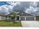 Charming one-story home featuring a well-manicured lawn, two car garage and a welcoming entrance at 190 Rain Berry Ave, Ruskin, FL 33570