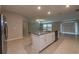 Island kitchen with stainless steel dishwasher opens to living area with windowed view at 190 Rain Berry Ave, Ruskin, FL 33570