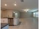 Kitchen featuring stainless steel dishwasher, granite counters, central island and an adjacent living area at 190 Rain Berry Ave, Ruskin, FL 33570