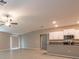 Bright kitchen with stainless steel appliances and white cabinetry overlooks an open living space at 190 Rain Berry Ave, Ruskin, FL 33570