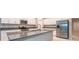 Kitchen with granite countertops, stainless steel appliances, white cabinets, and large island at 190 Rain Berry Ave, Ruskin, FL 33570