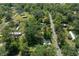 This aerial view highlights the neighborhood's blend of homes and mature trees along winding streets at 19496 Wildwood Dr, Brooksville, FL 34601