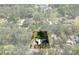 Aerial view of the property showcasing the home, yard, surrounding trees, and lot boundaries at 19496 Wildwood Dr, Brooksville, FL 34601