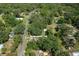 An aerial view captures a serene neighborhood with tree-lined streets, offering a glimpse of community charm and lush surroundings at 19496 Wildwood Dr, Brooksville, FL 34601