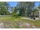 Expansive backyard with a large lawn, mature trees, and concrete, perfect for recreation and outdoor at 19496 Wildwood Dr, Brooksville, FL 34601