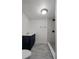 Modern bathroom with navy vanity, walk-in shower, and neutral gray tile flooring at 19496 Wildwood Dr, Brooksville, FL 34601