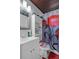 Bathroom with white vanity, mirrored cabinet, and shower featuring a red-themed shower curtain at 19496 Wildwood Dr, Brooksville, FL 34601