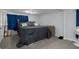 Bedroom with gray carpet, a large bed, and blue curtains offers a cozy retreat at 19496 Wildwood Dr, Brooksville, FL 34601