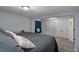 This bedroom features gray carpet, a large bed, and ample closet space at 19496 Wildwood Dr, Brooksville, FL 34601