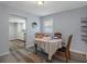 Cozy dining area with a quaint table, chairs, and a view into the kitchen at 19496 Wildwood Dr, Brooksville, FL 34601