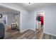 Inviting hallway with neutral paint, wood floors, leading to the laundry room and other rooms at 19496 Wildwood Dr, Brooksville, FL 34601